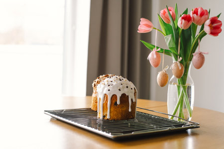 Baking a festive easter panettone with icing on a kitchen countertop during springtime preparationsの写真素材