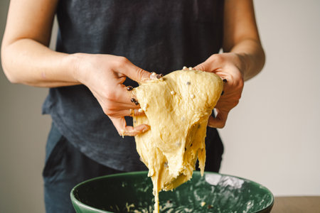 Woman prepares dough for bakingの写真素材
