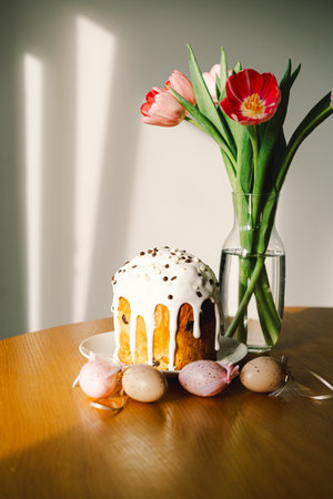 Happy Easter. Stylish easter cake, eggs on a table with spring flowers.の写真素材