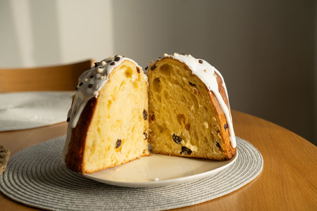 Baking a festive easter panettone with icing on a kitchen countertop during springtime preparationsの写真素材
