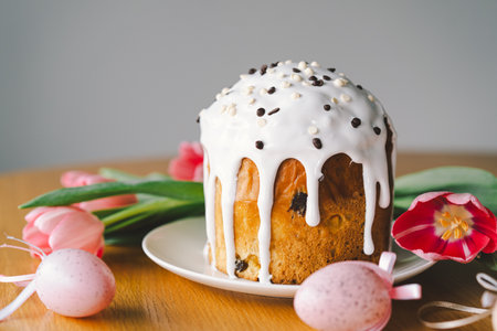 Happy Easter. Stylish easter cake, eggs on a table with spring flowers.の写真素材