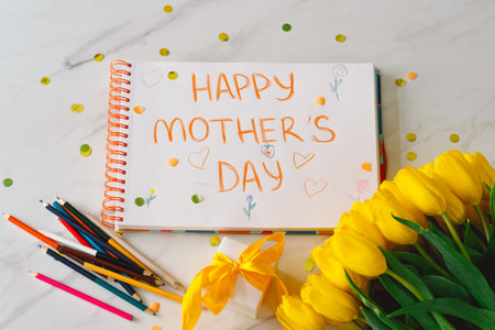 A boy diligently creating a heartfelt Mothers Day cardの写真素材