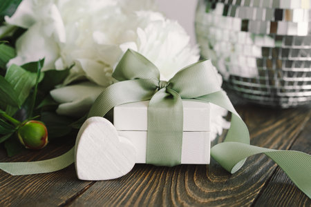 Bouquet of beautiful white peonies with gift boxes on wood backgroundの写真素材