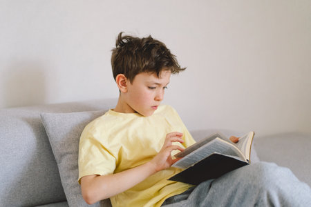 A boy is reading the holy bible.の写真素材