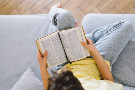 A boy is reading the holy bible.の写真素材