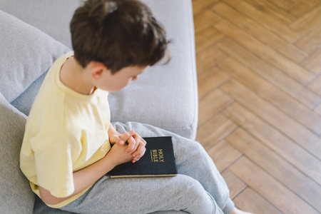 A boy is reading the holy bible.の写真素材