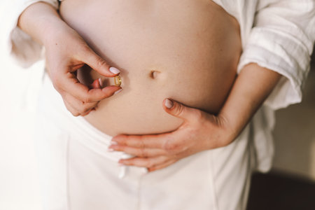 Pregnant young woman holding vitaminsの写真素材