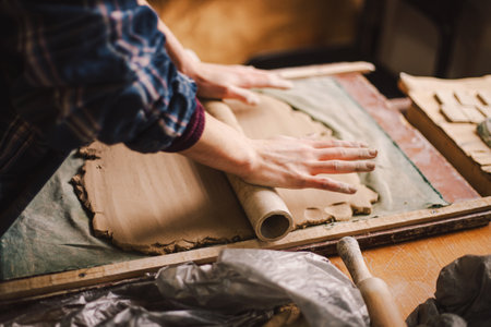 Hands skillfully shape a clay pot in a pottery studioの写真素材