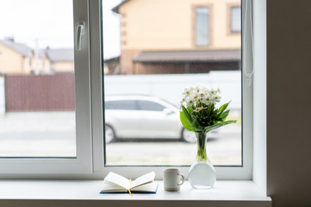 Book, cup tea and white flower. Romantic conceptの写真素材