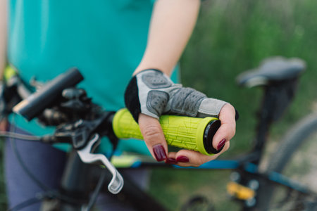 Close Up of a Womans Hand on a Mountain Bike Handlebarsの写真素材
