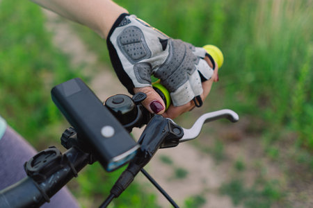 Close Up of a Womans Hand on a Mountain Bike Handlebarsの写真素材
