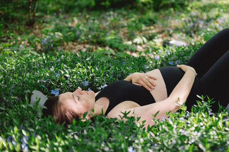 Pregnant woman doing fitness outdoors.の写真素材