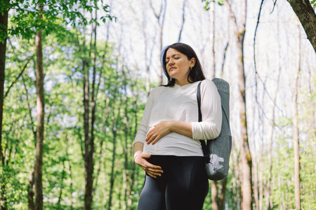 Pregnant woman doing fitness outdoors.の写真素材