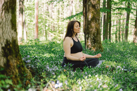 Pregnant woman doing fitness outdoors.の写真素材