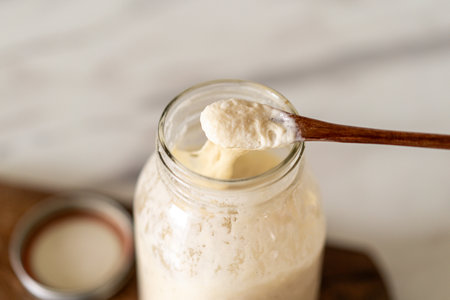 Baking sourdough bread in a cozy kitchen with fresh dough, starter preparationの写真素材