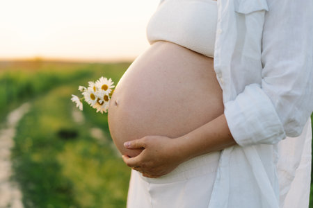 Pregnant woman in a field. Expecting joyful moments