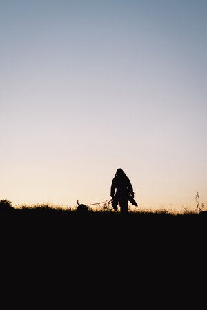 Human and a dog. Teen girl and her dog on the field backgroundの写真素材