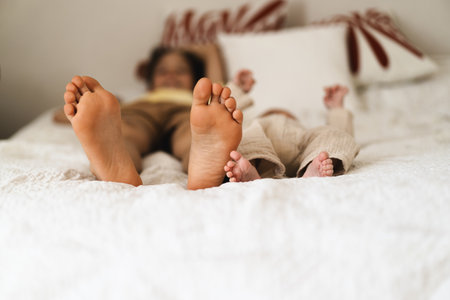 Two pairs of feet two little boys brothersの写真素材