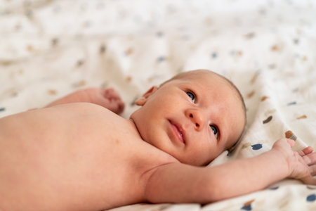 A newborn baby lying on a blanketの写真素材