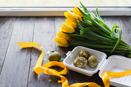 Spring festive composition with yellow tulips and decorative eggs. Easter holiday