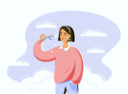 Happiness, mental health and emotional balance. Calm pretty girl smelling a flowerの写真素材