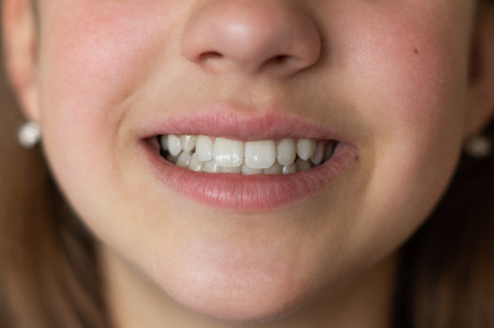 Even white healthy teeth of a child or person close-up front view. Correct bite of teethの写真素材