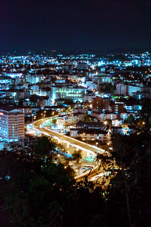 The night scene of highlighted city road made from the Big Buddha Hill, Pattaya, Thailand. Cars, buildings in the outdoor lamp post lights. Vibrant colors, night rhythm and atmosphere of busy cityの写真素材