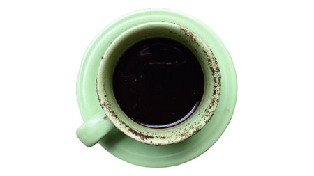 A Cup of Strong Black Coffee in a Green Ceramic Mug with a Small Saucer, Isolated on White Background, Classic Hot Beverage for Cafe Menu, Coffee Lovers, and Advertisingの写真素材