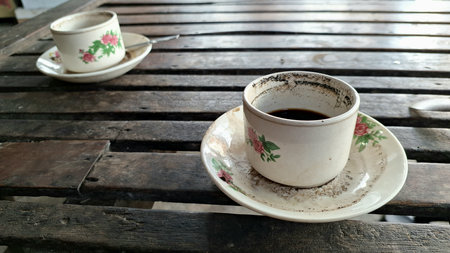 Coffee grounds grains that stick to the edge of the cup. Typical Indonesian Javanese Coffee. Original coffee with simple processingの写真素材