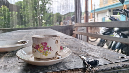 a cup of strong black coffee with lots of pulp in a unique and antique glass cupの写真素材
