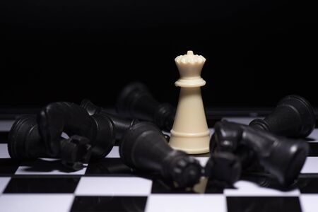 One  chess pieces staying against black chess piecesの写真素材