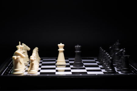 One  chess pieces staying against black chess piecesの写真素材