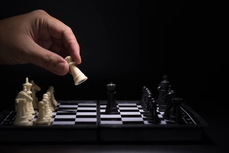 One  chess pieces staying against black chess piecesの写真素材