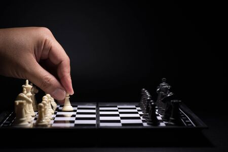 One  chess pieces staying against black chess piecesの写真素材