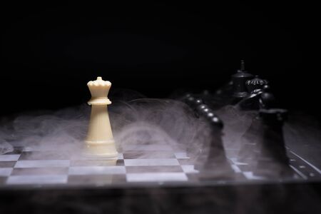 One  chess pieces staying against black chess piecesの写真素材