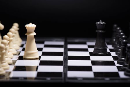 One  chess pieces staying against black chess piecesの写真素材