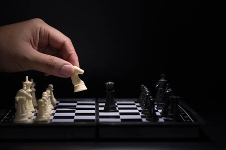 One  chess pieces staying against black chess piecesの写真素材