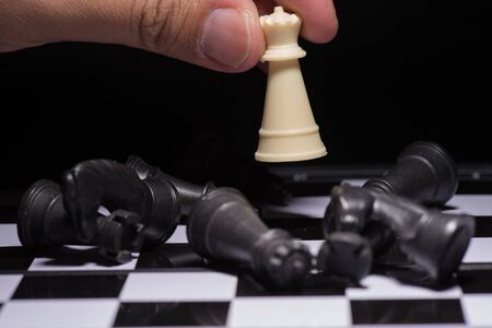 One  chess pieces staying against black chess piecesの写真素材