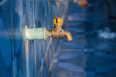 Chrome faucet with blue pvc pipe.