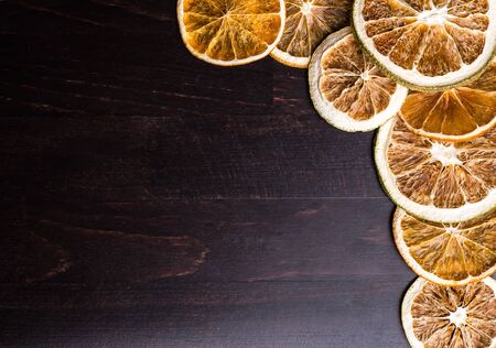 Dried slices of orange, lemon on a black backgroundの写真素材