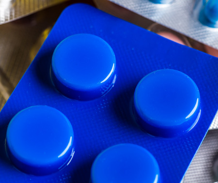 Medicine green and yellow pills or capsules. Antibiotic closeup.の写真素材