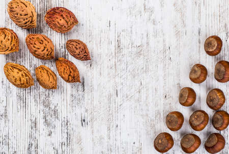 Assorted nuts in white wooden surface.の写真素材