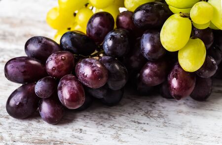 Red and white grapes over stone table.の写真素材