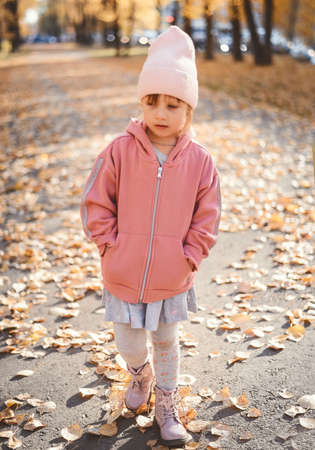 A child plays with leaves in autumnの写真素材