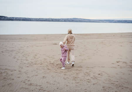 Mom and daughter play summer on the beachの写真素材