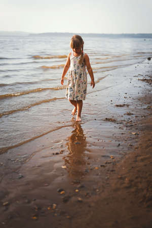 Mom and daughter play summer on the beachの写真素材