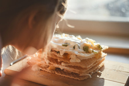 a child cooks a cake for his mother on a holiday home selfの写真素材