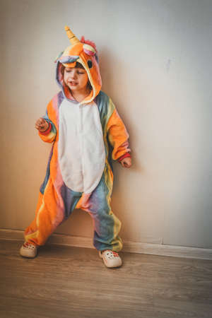 a small child plays with a Christmas tree and a Christmas tree toy in the new year at home with his familyの写真素材