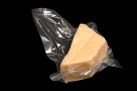 vacuum packed cheese on the black backgroundの写真素材