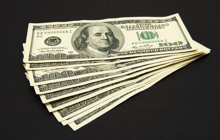 Dollars banknotes isolated on black background.の写真素材